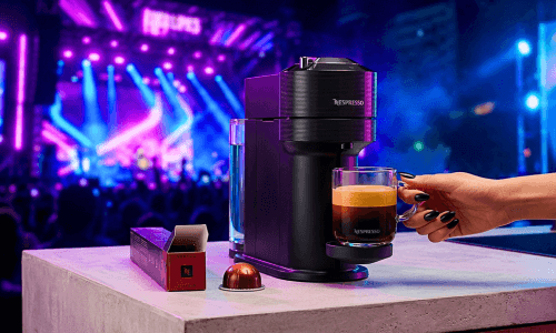 Dua Lipa Nespresso Vertuo World campaign aesthetic featuring a Vertuo Next machine and coffee mug.